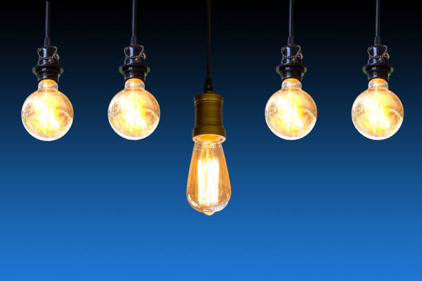 istock Vintage light bulb hanging over dark blue background, Idea concept. 1097305360