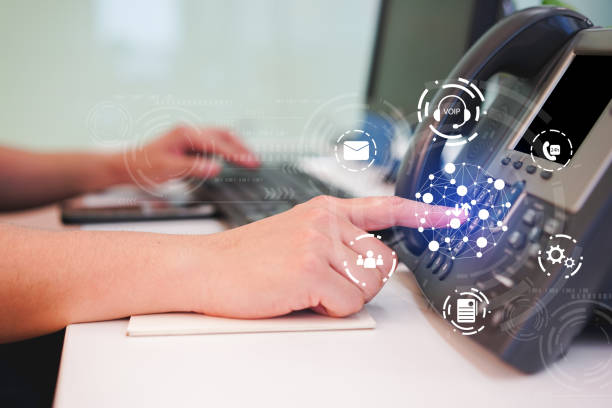 close up employee call center man hand point to press button number on telephone office desk with icon virtual interface of communication technology concept close up employee call center man hand point to press button number on telephone office desk with icon virtual interface of communication technology concept voip stock pictures, royalty-free photos & images