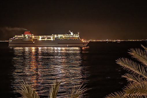 View of ferry boat arriving to the Mediterranean port of Almeria at night.