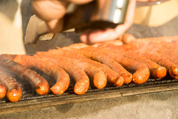 istock Grilled sausages on grill with smoke 1097314122