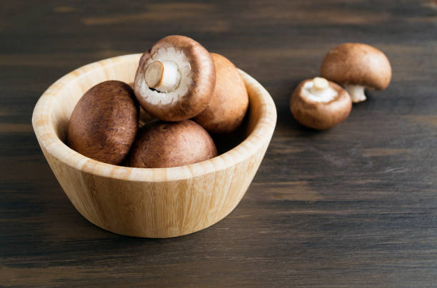 istock Fresh king brown mushrooms on wooden background. 1097316318