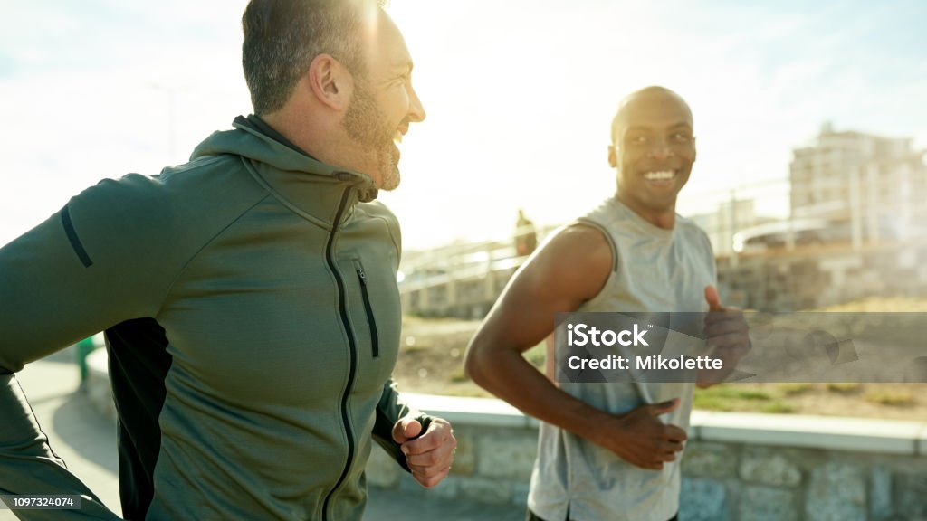 Let's get to those goals Shot of two sporty men exercising together outdoors Men Stock Photo