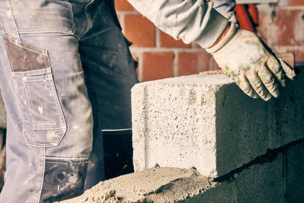 istock Real construction worker bricklaying the wall indoors. 1097325532