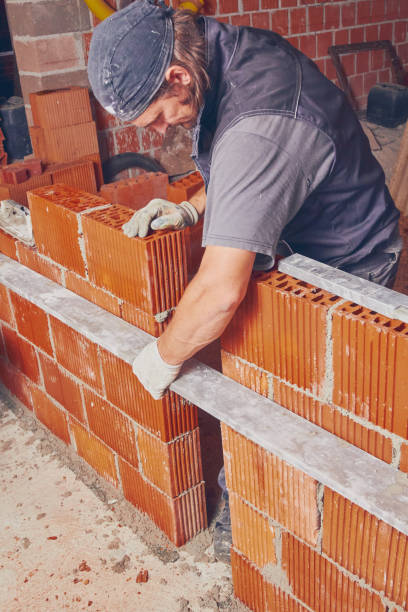 istock Real construction worker bricklaying the wall indoors. 1097327366