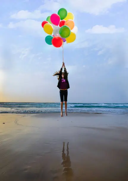 Photo of Girl flying with balloons