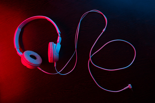 headphones on dark background in neon light