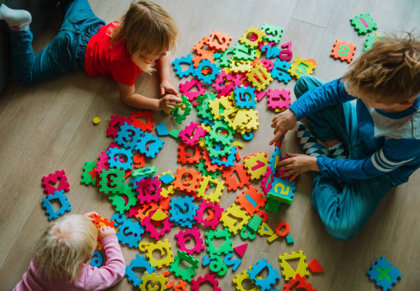 istock kids playing with puzzle, learning numbers and shapes 1097338468