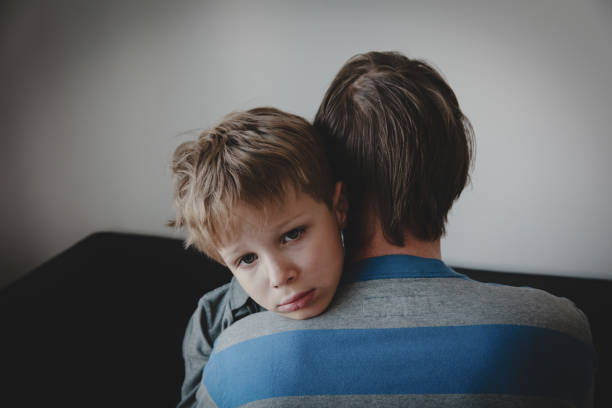 istock father comforting stressed sad son, depression and sorrow 1097339356