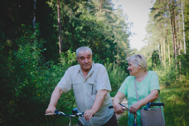 istock active senior couple riding bikes in nature 1097340604