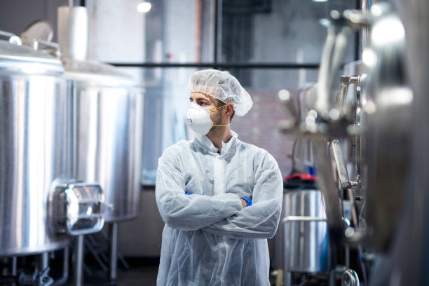 istock Portrait of professional technologist in protective uniform looking aside. 1097341880