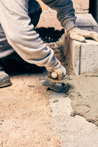 istock Real construction worker bricklaying the wall indoors. 1097342290