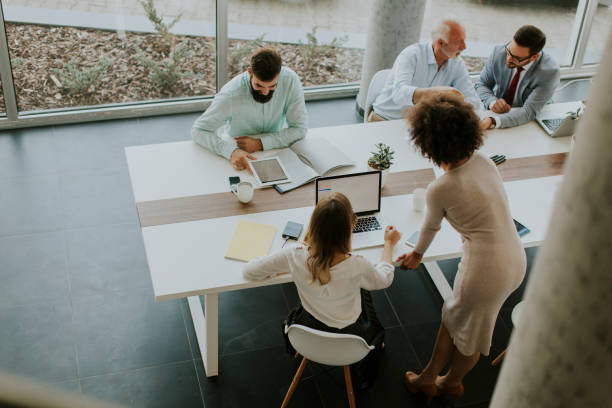istock Joyful multiracial business team at work in modern office 1097342364