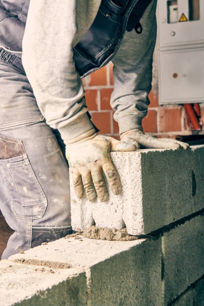 istock Real construction worker bricklaying the wall indoors. 1097343780
