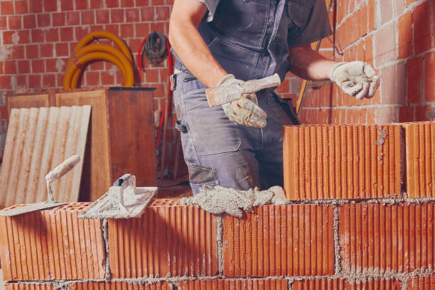 istock Real construction worker bricklaying the wall indoors. 1097346034