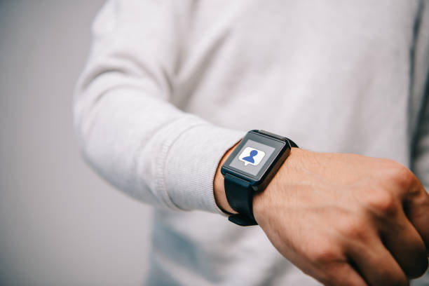 cropped view of man with smartwatch with multimedia icon