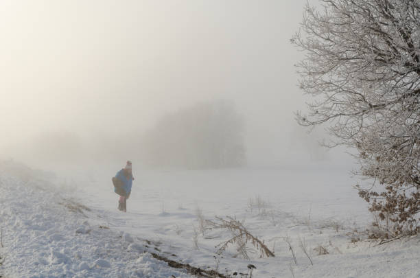 istock Young girl is walking in fog 1097346404