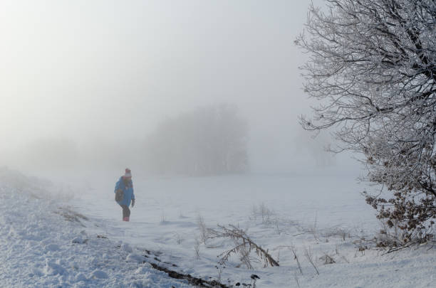istock Young girl is walking in fog 1097346514