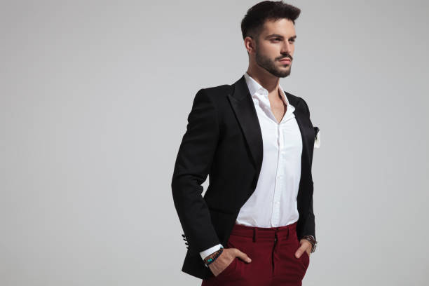istock handsome smart casual man holds pockets and looks to side 1097354090