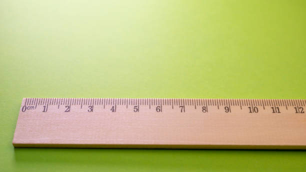istock Wooden ruler on green background. View from above with copy space 1097356218