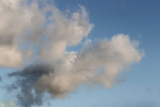 istock white  and greys clouds  in a blue sky background 1097356588