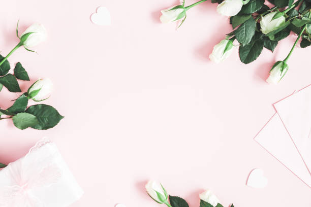 istock Valentine's Day composition. Gift box, white rose flowers, envelope on pastel pink background. Valentine's day, Mother's day concept. Flat lay, top view, copy space 1097362406