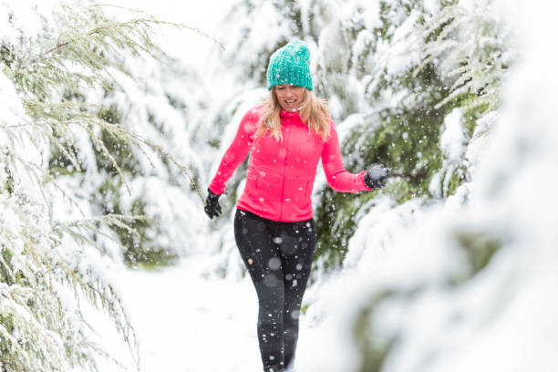 istock Cheerful woman enjoying snowy winter 1097363490
