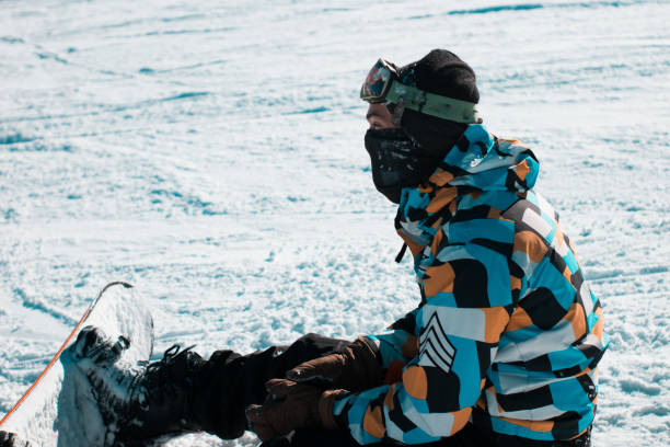 istock tired snowboarder fallen on the ground taking a break 1097373500