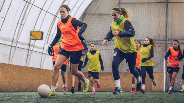 Women on soccer practice Group of women, girls soccer team on the field indoors, training together. teen goalie stock pictures, royalty-free photos & images