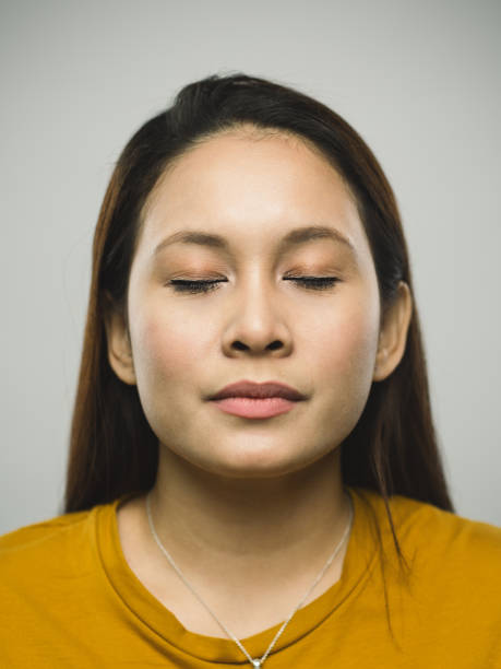 istock Real malaysian young woman with blank expression and closed eyes 1097375330