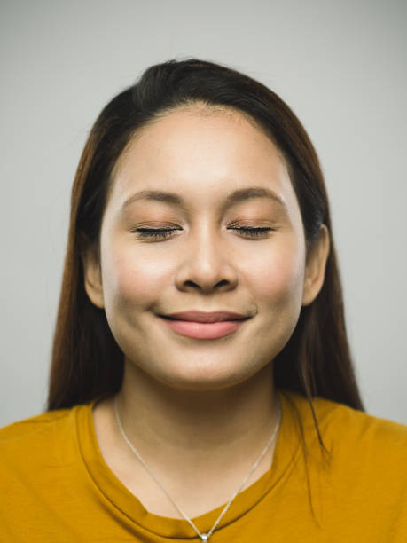 istock Real malaysian young woman with happy expression and eyes closed 1097375434