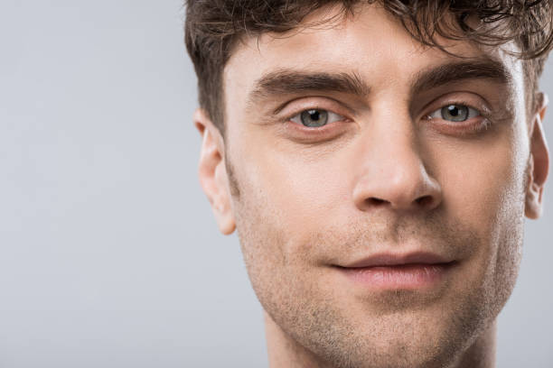 istock portrait of handsome young smiling man isolated on grey 1097383836