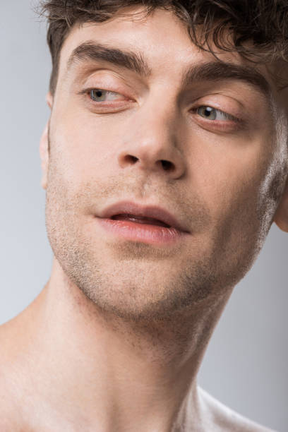 istock portrait of handsome young macho isolated on grey 1097383858
