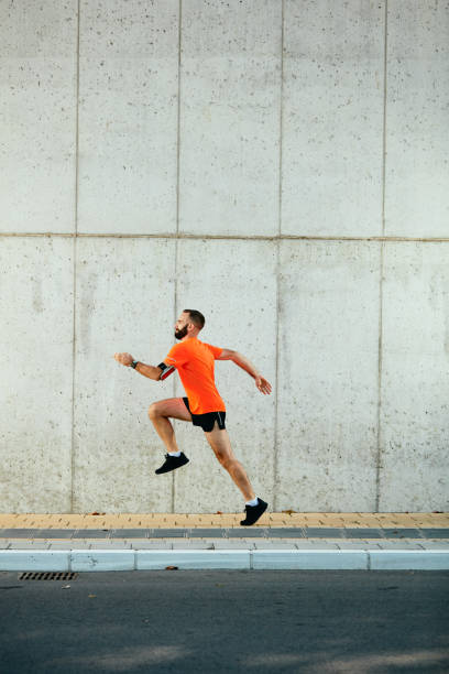 istock Young bearded man running on the street. 1097384560