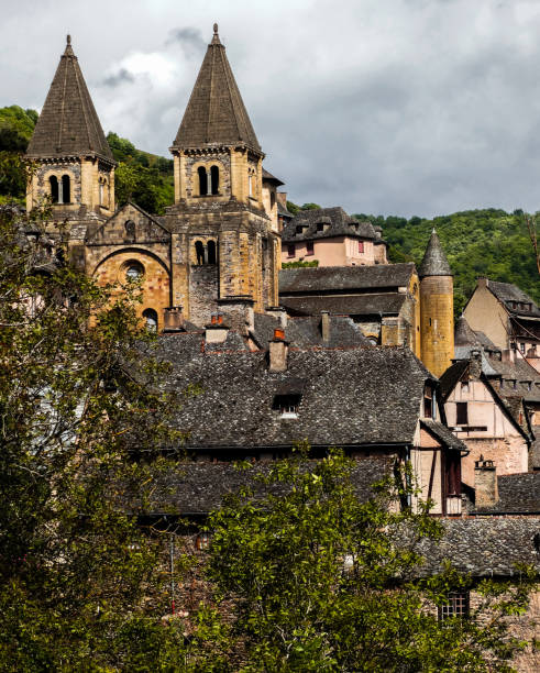 Conques, Saint Foy abbey, with grey clouds, Aveyron, France