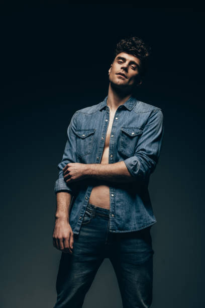 istock handsome stylish man posing in denim clothes isolated on grey 1097385116