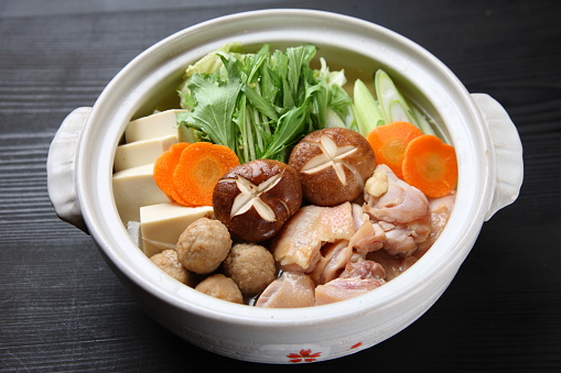 studio shot of CHANKO-NABE Japanese hot pot,chicken with vegetables on black background