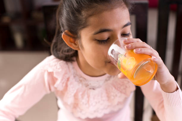 istock Girl drinking juice 1097390106