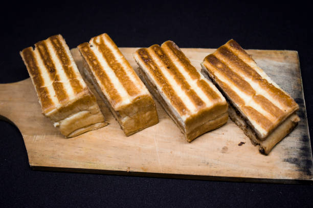 istock Roasted sliced bread with with peanut butter inside. Isolated on black. 1097390168