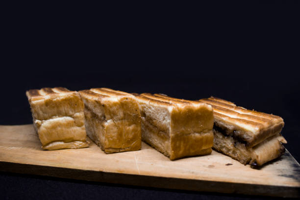 istock Roasted sliced bread with with peanut butter inside. Isolated on black. 1097390170