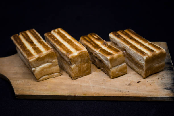 istock Roasted sliced bread with with peanut butter inside. Isolated on black. 1097392432