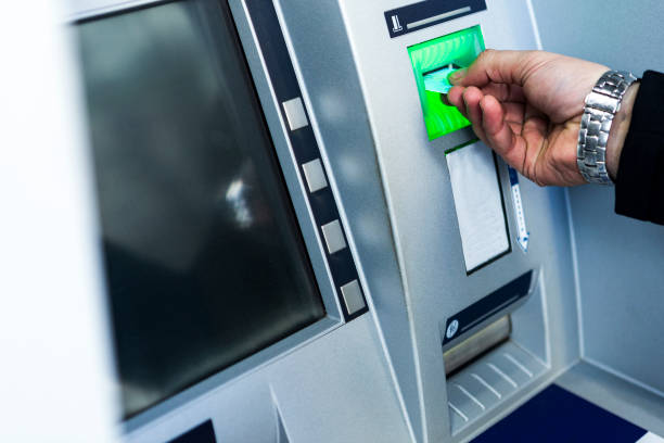 istock withdrawing money from an ATM. 1097392534