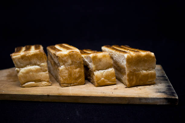 istock Roasted sliced bread with with peanut butter inside. Isolated on black. 1097394680