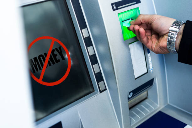 istock withdrawing money from an ATM. no money 1097395112