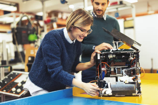 istock Young attractive students of mechatronics working on project 1097395600