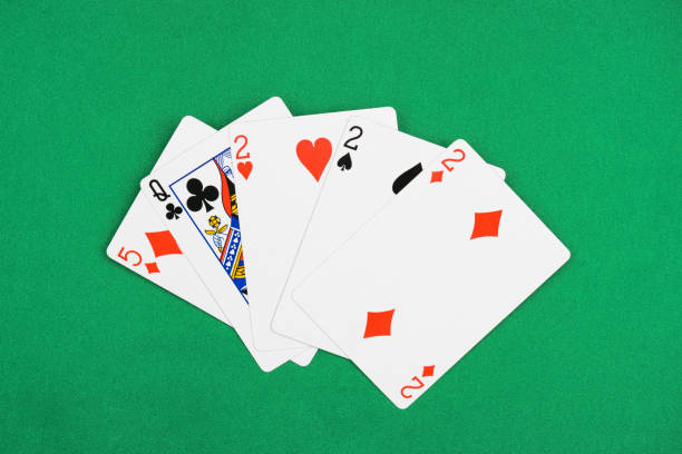 istock top view of green poker table with unfolded playing cards combination with different suits 1097396128