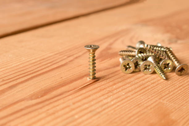 istock Screws on a wooden workbench. The concept of work 1097398206