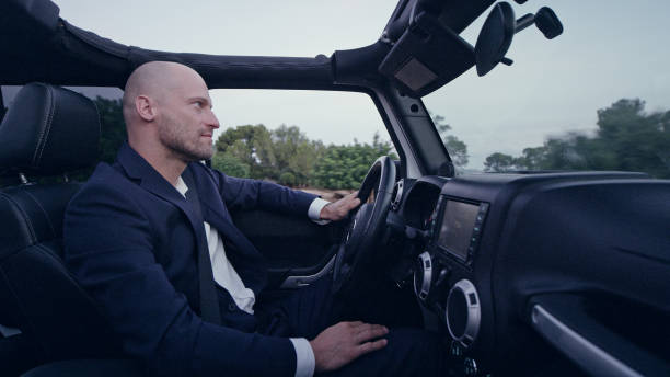 istock Businessman driving SUV. Escaping to exotic scenery 1097398452