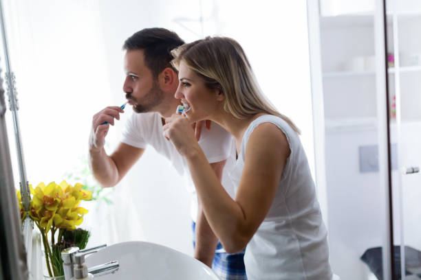 istock Attractive couple brushing teeth in morning together 1097399392