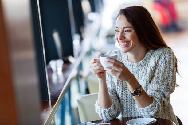istock Young beautiful woman drinking coffee in restaurant 1097399394