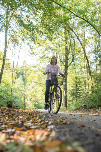 istock Low angle view of young woman riding a bicycle 1097400316